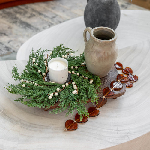 GP Home holiday styling: amber heart garland and greenery tray.