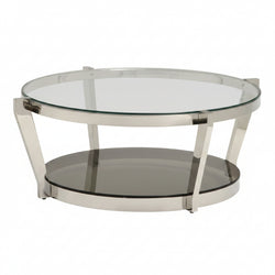 Round cocktail table with a clear glass top and a mirrored bottom, featuring a polished chrome finish and a stainless-steel frame with a tapered base.