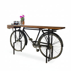 Table made from an old bicycle with a wooden top on a white background