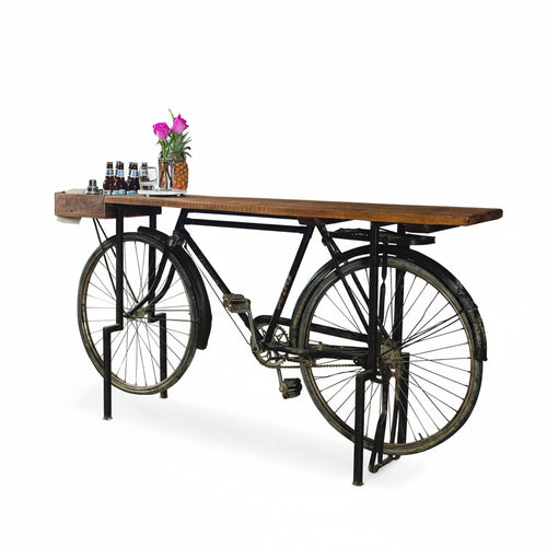 Table made from an old bicycle with a wooden top on a white background