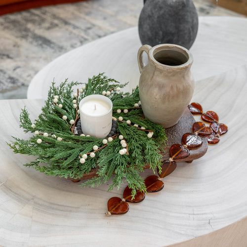 GP Home holiday styling: amber heart garland and greenery tray.