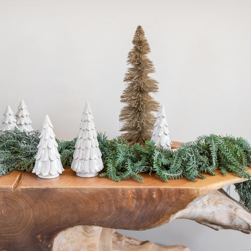 GP Home holiday styling: ceramic trees and winter greenery.