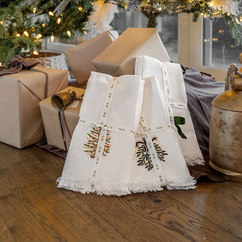 GP Home holiday styling: embroidered hand towels and rustic bells.