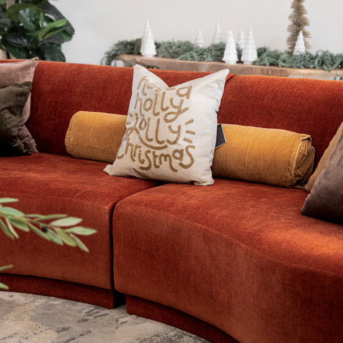 GP Home holiday styling: jolly christmas pillow on a velvet sofa.