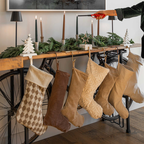 GP Home holiday styling: layered stockings and candles.