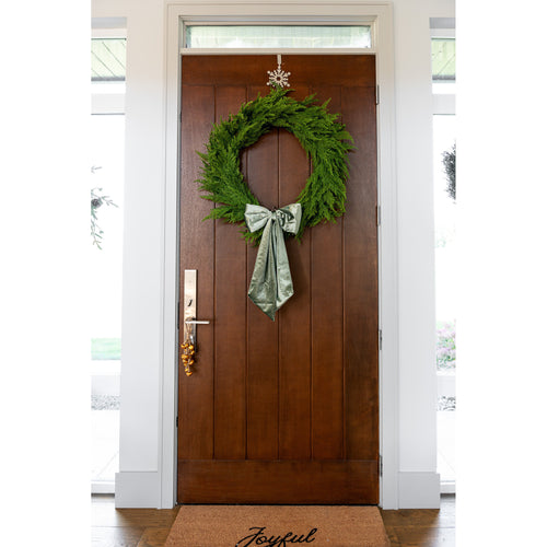 GP Home holiday styling: sage velvet bow wreath and joyful doormat.
