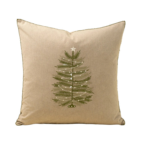 Decorative pillow with a Christmas tree design on a beige background